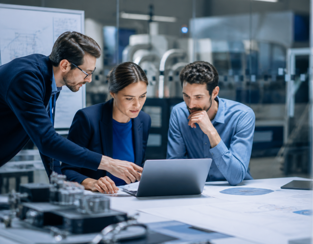 Colleagues collaborating over a laptop